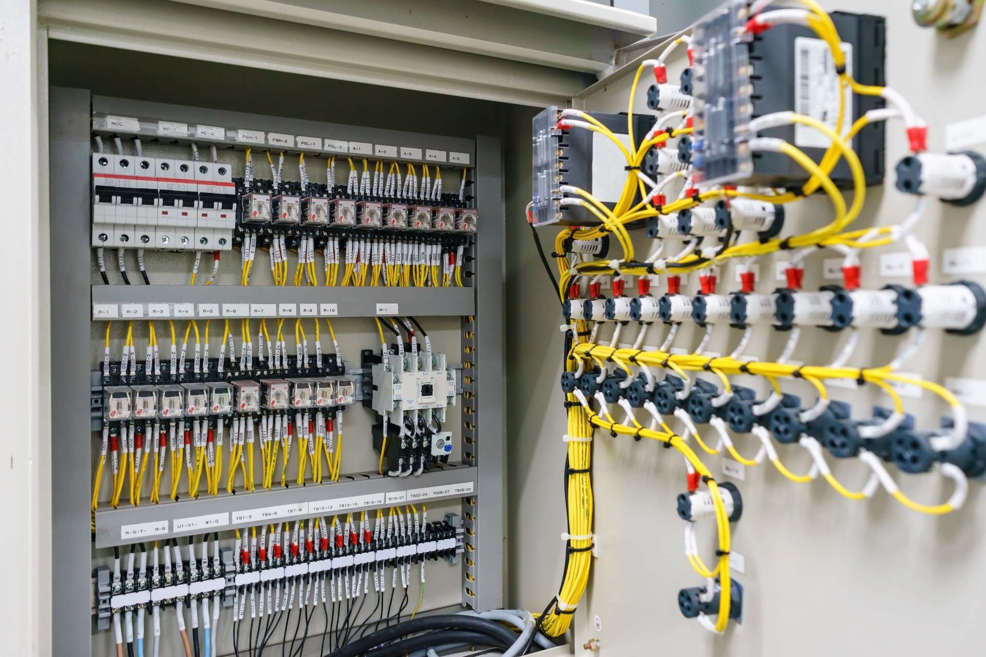 Internal machine control panel with labelled yellow wiring